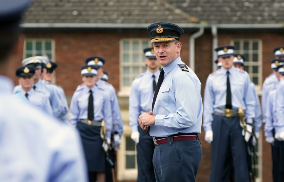 Mike Wigston standing in the middle of a group of Royal Air Force (RAF) airmen