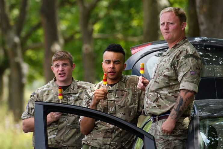 Three Royal Air Force (RAF) airmen eating ice lollies