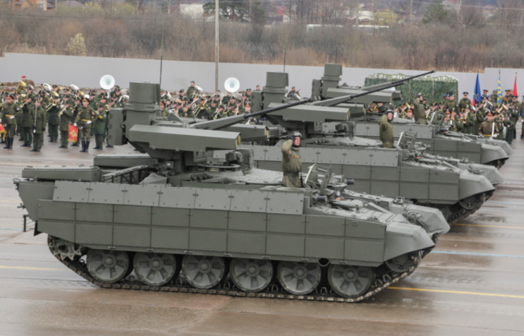 Line of BMPT Terminators driving down a rain-soaked street