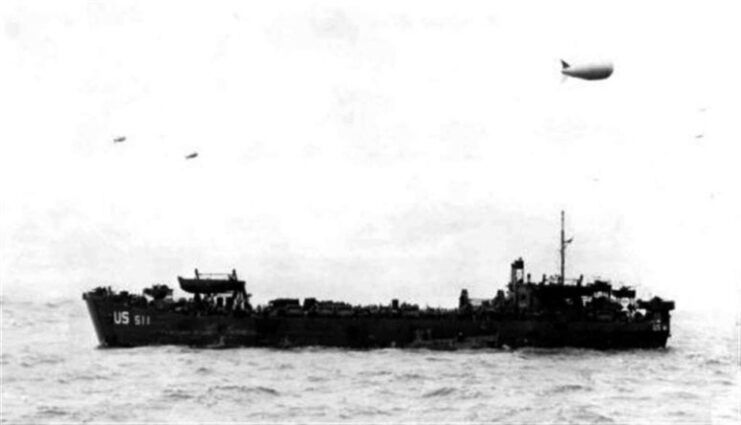 Blimp flying over the USS LST-511 while at sea