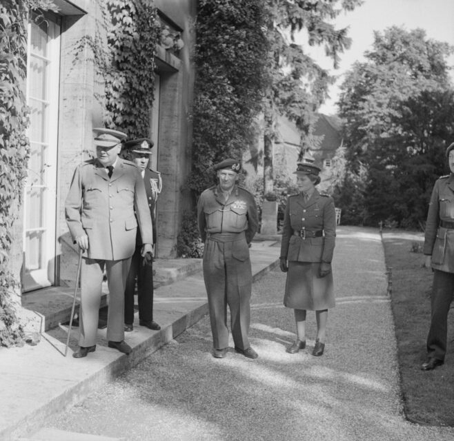 Mary Soames (née Spencer-Churchill) standing outside a building with Bernard Montgomery, Winston Churchill and other officials