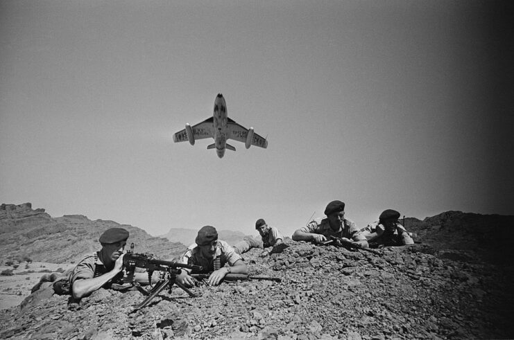 Hawker Hunter flying over members of the 45 Commando Royal Marines