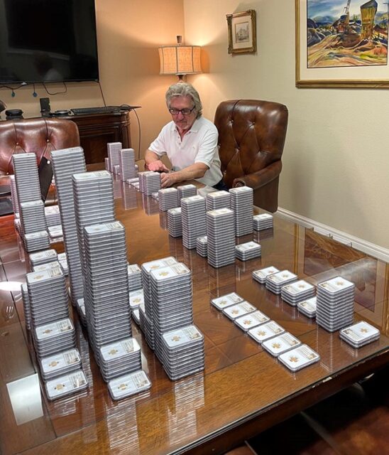 Jeff Garrett sitting at a table stacked with American Civil War-era coins