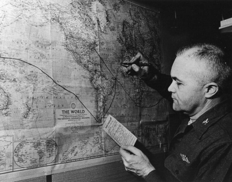 Capt. Edward L. Beach Jr. charting the USS Triton's (SSRN-586) route during Operation Sandblast on a map