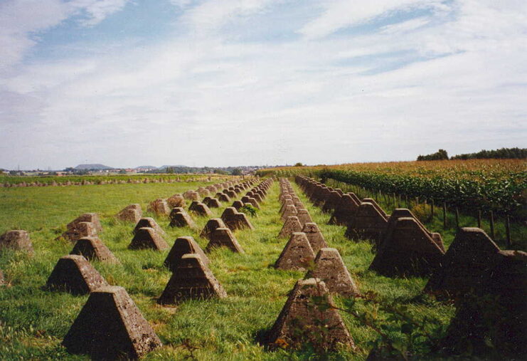 Rows of Dragon's Teeth next to a farmer's field