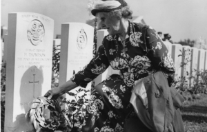 Jane Thompson laying a wreath at her son's grave