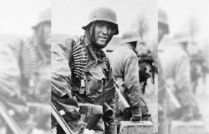 Hans Tragarsky standing in uniform, with an ammunition belt around his shoulders
