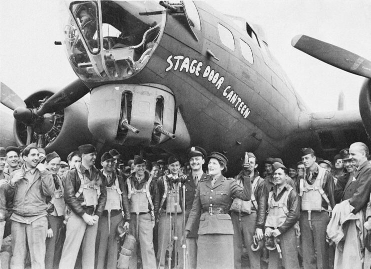 Airmen and Mary Soames (née Spencer-Churchill) standing beneath the Boeing B-17 Flying Fortress 'Stage Door Canteen'