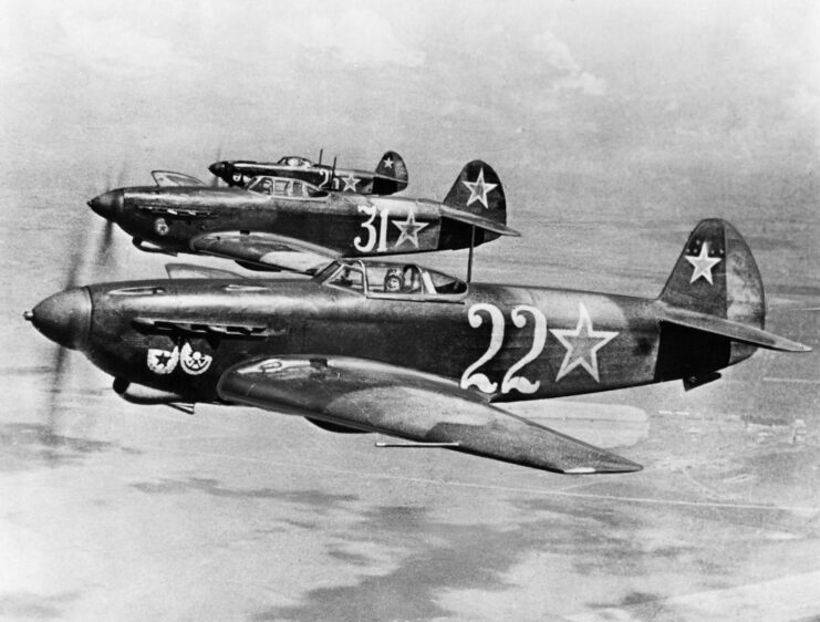 Three Yakovlev Yak-9s in flight