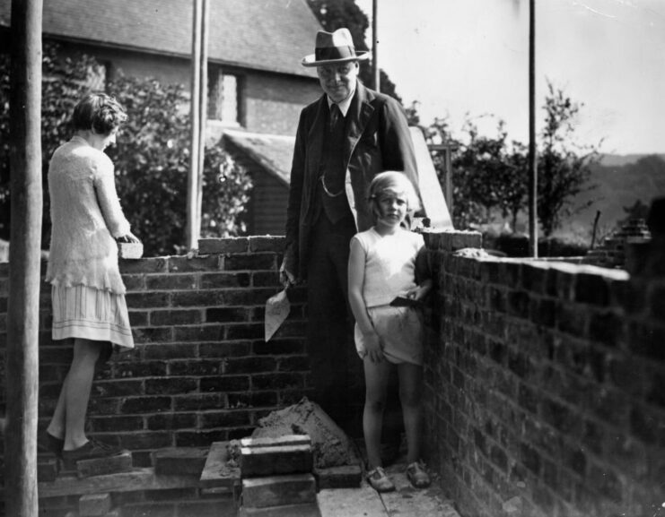 Winston Churchill standing with his daughters, Sarah and Mary