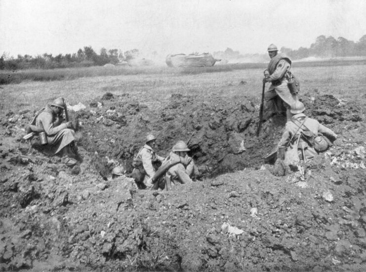 French infantrymen sitting in a shell hole