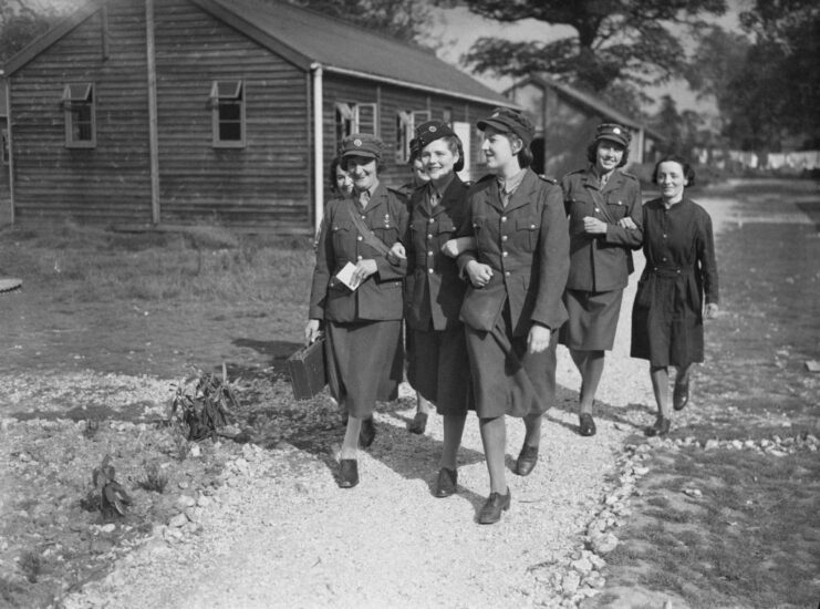 Mary Soames (née Spencer-Churchill) walking along a path with other members of the Auxiliary Territorial Service (ATS)