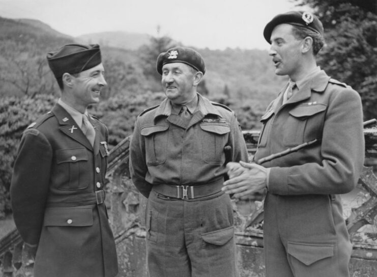 Unknown lieutenant colonel, a captain with the US Army Rangers and Simon Fraser, 15th Lord Lovat standing together outside