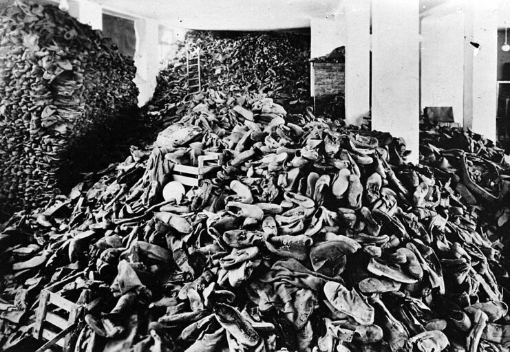 Piles of shoes in a large room at Auschwitz