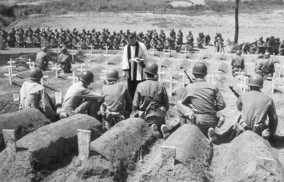 US Army Chaplain performing a funeral service with several soldiers in attendance