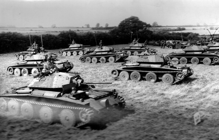 Mk V Covenanter tanks driving through a grassy field