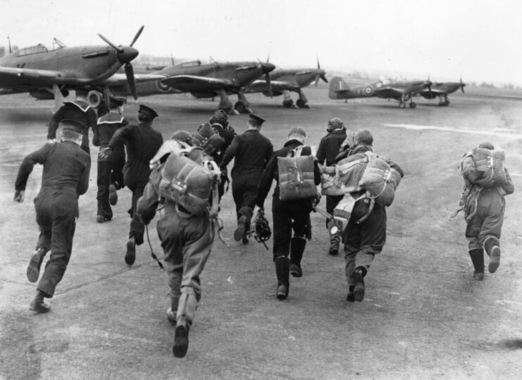Royal Air Force (RAF) pilots running toward their aircraft
