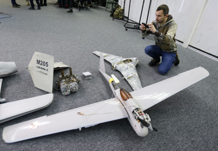 Photographer taking a picture of Orlan-10, Granat-3, HESA Shahed-136 and Eleron-3 drones