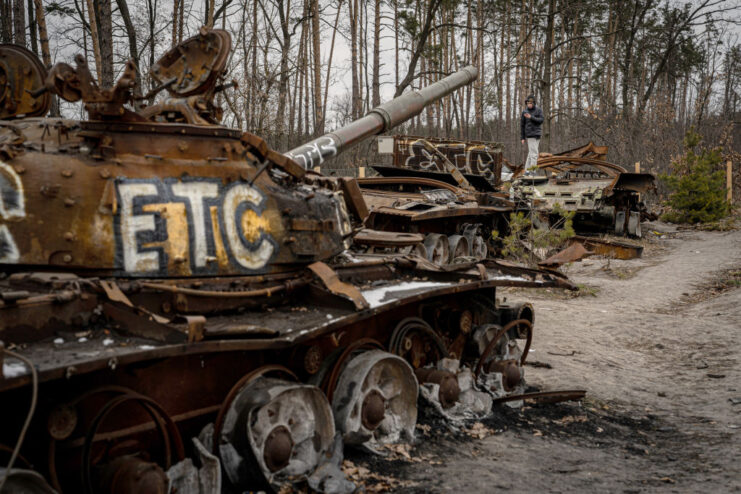 Burned-out tanks along the side of a road