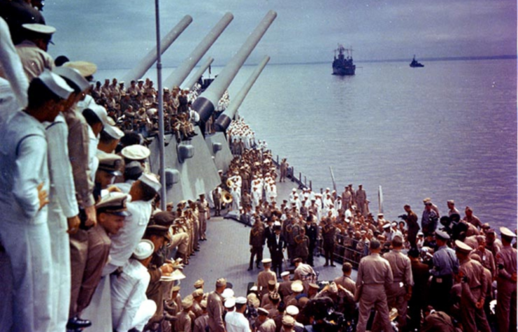 Crewmen aboard the USS Missouri (BB-63) watching Allied and Japanese officials sign the Instrument of Surrender