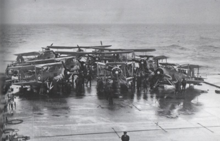 Crewmen standing around Fairey Swordfish on the flight deck of the HMS Victorious (R38)