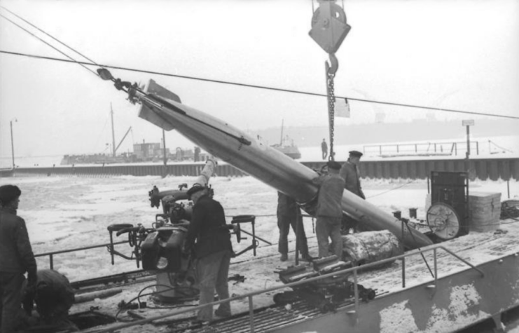 Dock workers loading a torpedo onto a U-boat