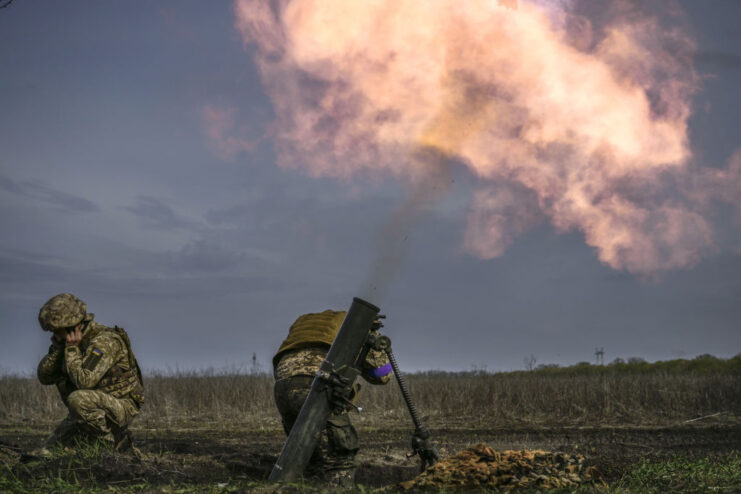 Two Ukrainian soldiers firing munitions on the frontlines