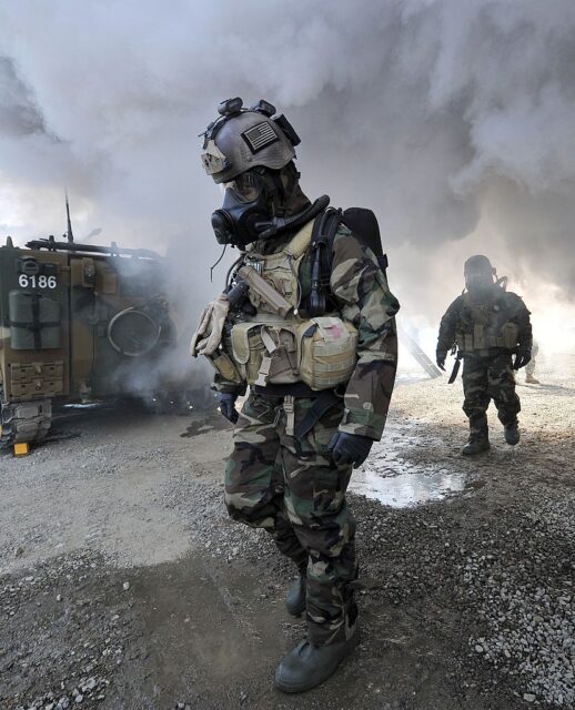Two US soldiers walking in chemical warfare gear