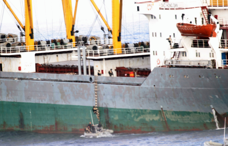 US Navy personnel boarding the MV Dai Hong Dan via the water