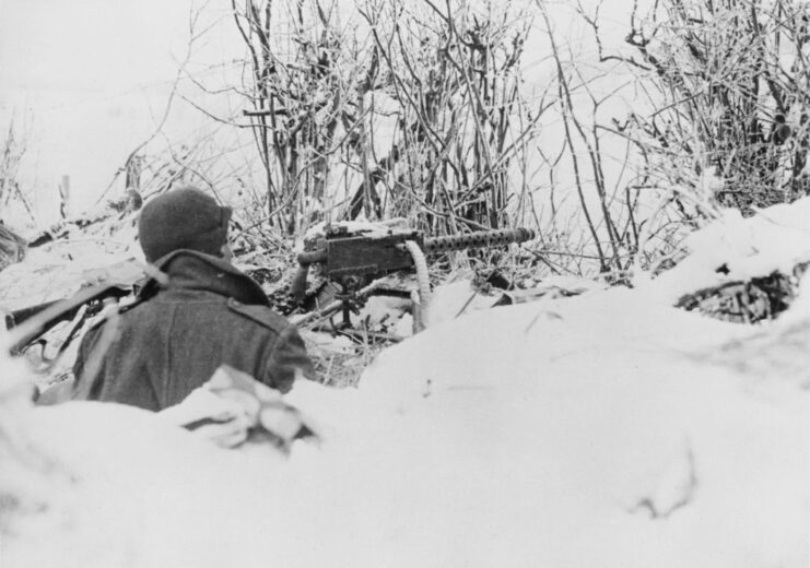 Member of the 101st Airborne Division manning a machine gun in the snow