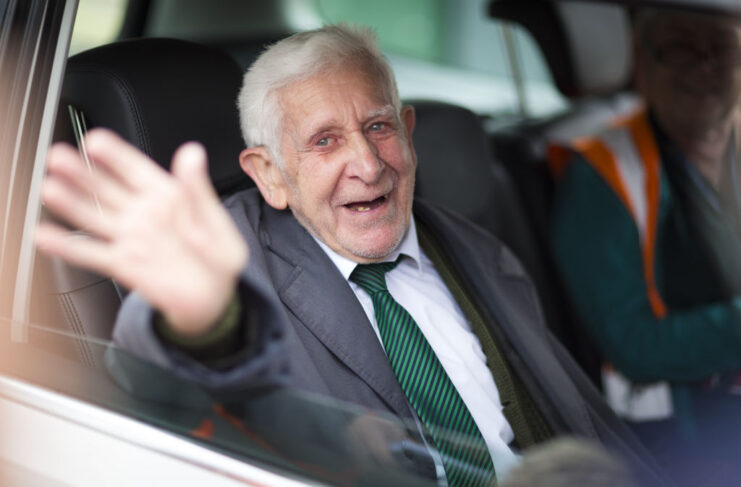 Bernard Jordan waving from a car