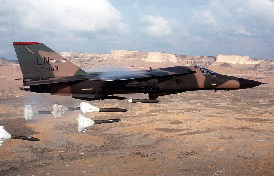 General Dynamics F-111F Aardvark dropping Mark 82 bombs mid-flight