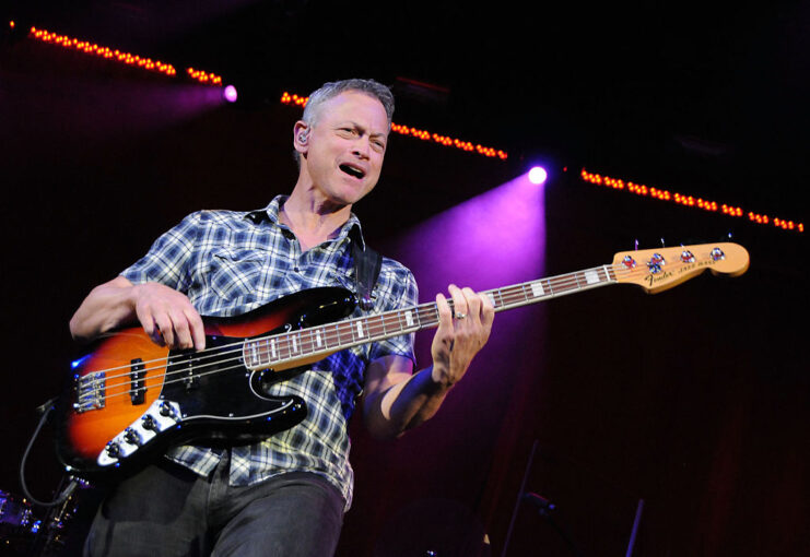 Gary Sinise playing the bass on stage
