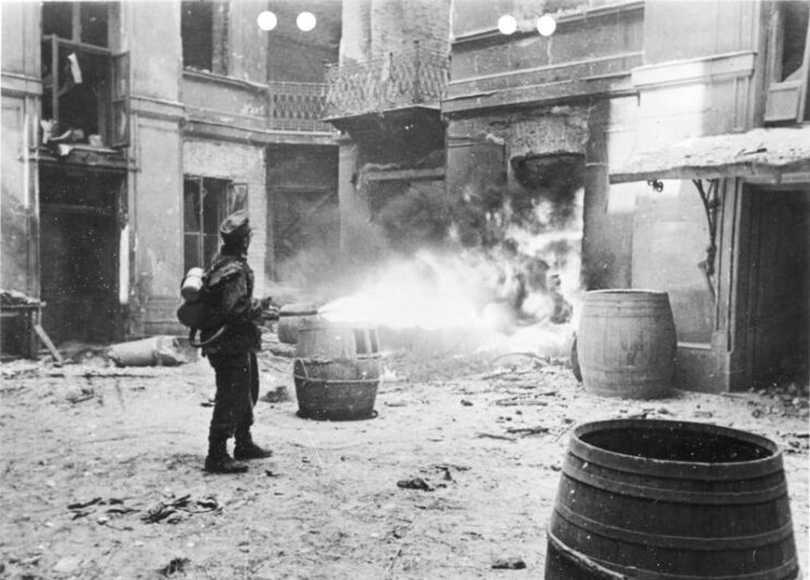 German soldier firing a flamethrower at a building