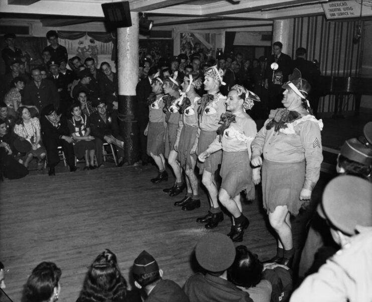 Group of soldiers performing in the middle of a crowded room