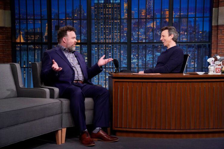 Connor Ratliff speaking with Seth Meyers on the set of 'Late Night with Seth Meyers'