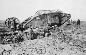 British soldiers standing around a broken down Mark I tank