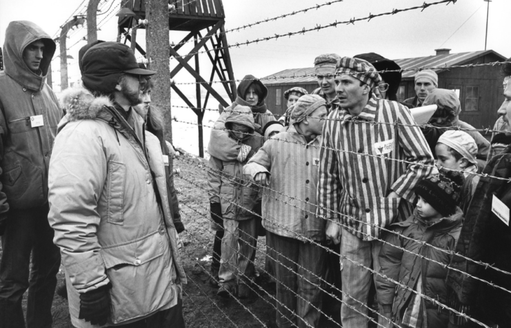 Steven Spielberg speaking with members of the cast on the set of 'Schindler's List'