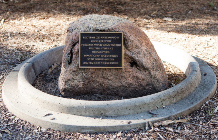 Stone memorial with a plaque attached to it