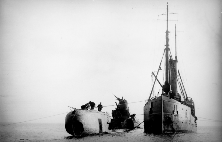 HMS Thetis (N25) beside a recovery ship at sea