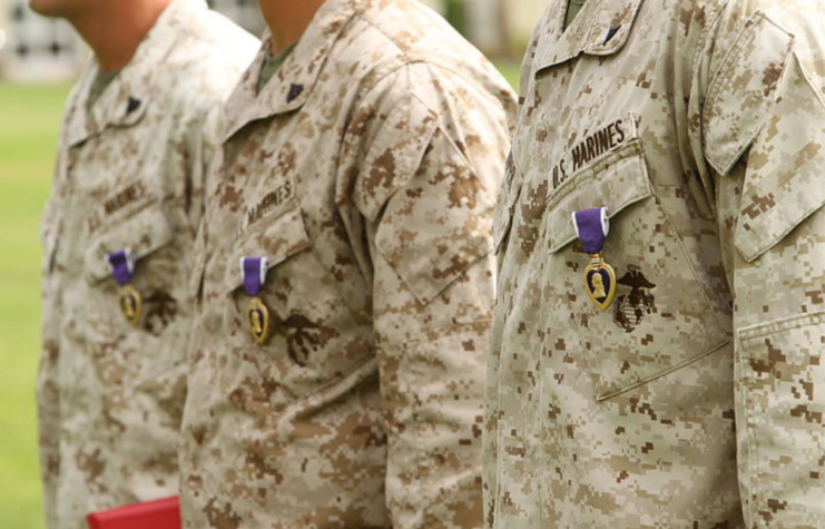 Three US Marines with Purple Hearts pinned to their chests