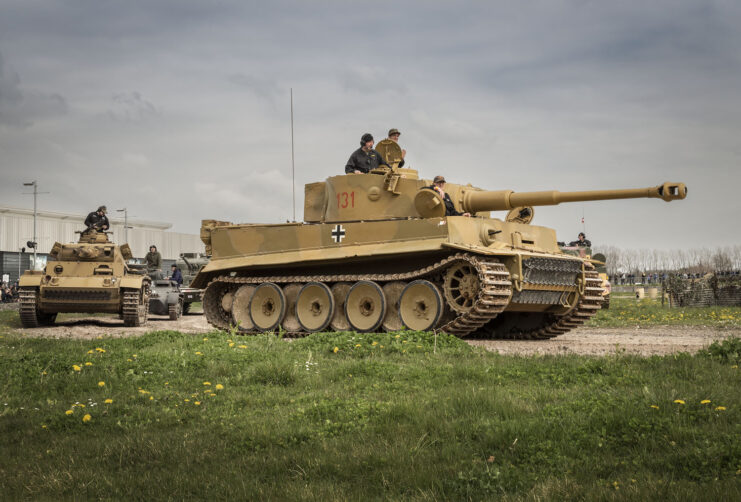 Tiger 131 and other armored vehicles driving along a dirt course