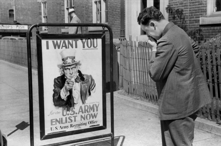 Man staring at a US Army recruitment poster