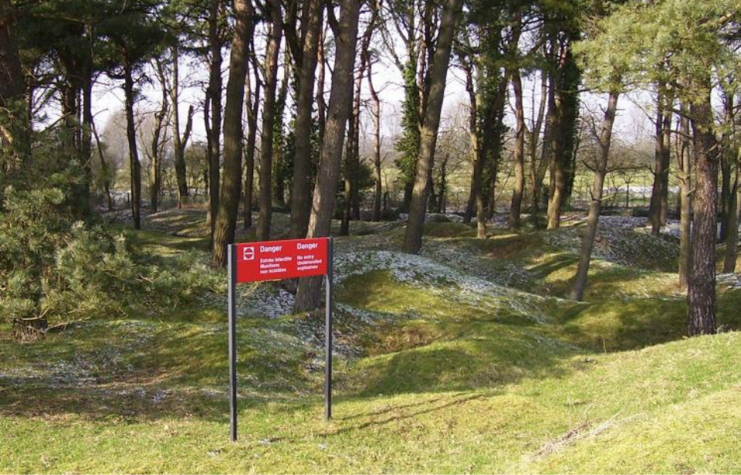 Warning sign placed along the exterior a wooded area at Vimy Ridge