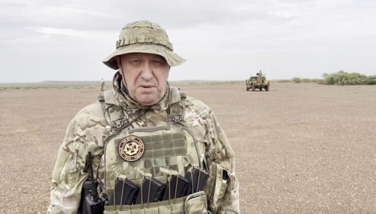 Man believed to be Yevgeny Prigozhin standing in the middle of a desert area in military fatigues