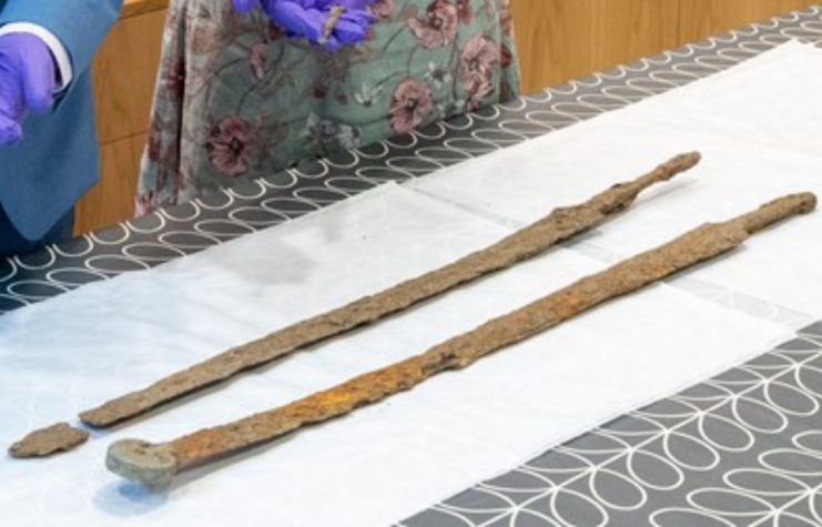 Two ancient Roman swords placed on a table