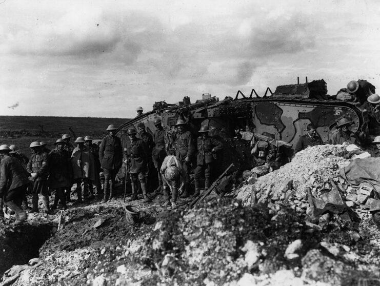 Troops standing in front of a Mark I tank