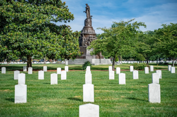 Graves at Arlington National Cemetery, with the Confederate monument standing in the background