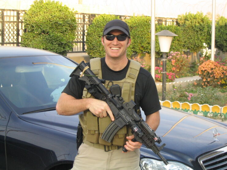 Glen Doherty wearing a tactical vest and holding a weapon
