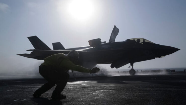 Petty Officer 1st Class Rey White directing a Lockheed Martin F-35B Lightning II on the flight deck of the USS Essex (LHD-2)